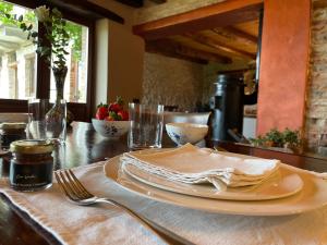a table with a plate and a napkin on it at Casa Vecchia Bed&Breakfast in Bossolasco