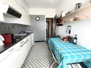 a kitchen with a table in the middle of it at BELVEDERE - Lakeview Apartment 10 min from Lugano in Porza