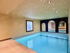 a swimming pool in a house with a ceiling at Axaari - VIEW & SUNNY chalet 10 pers in Nendaz