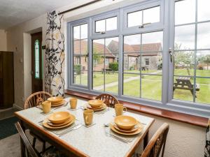a dining room with a table and a large window at Oak Tree in Weston-super-Mare