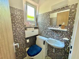 a bathroom with a sink and a toilet and a mirror at BELVEDERE - Lakeview Apartment 10 min from Lugano in Porza +2 photos