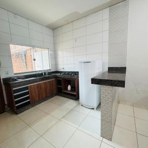 a kitchen with a refrigerator and a counter in it at casa mobiliada em gurupi in Gurupi +1 photo