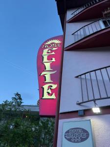 a hotel sign on the side of a building at Hostel Elite in Băile Herculane