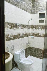 a bathroom with a toilet and a shower at Quiet Rooms 2 Serviced Apartments in Riyadh +22 photos