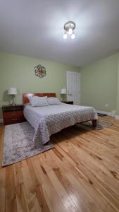 a bedroom with a bed and a wooden floor at Small Town Bound Inn in Vernon River