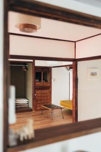 a view of a living room from a mirror at 離島の宿 Nawanawa Backpackers in Matsuyama