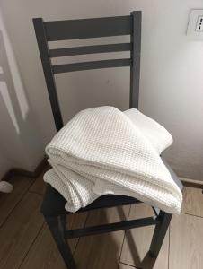 a black chair with a white pillow on it at Arcadia Hosting Piazza XX Settembre in Bologna
