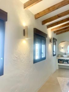 a bathroom with a white wall with two windows at Casa Marítima in Altea
