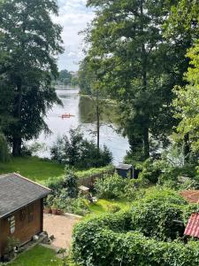 a view of a lake with a boat in the water at Ferienwohnung Vogelnest in Templin +8 photos