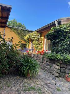 a house with a stone wall and some plants at Ferienwohnung Vogelnest in Templin
