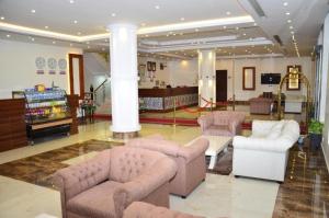 a lobby with couches and chairs in a building at Quiet Rooms 2 Serviced Apartments in Riyadh