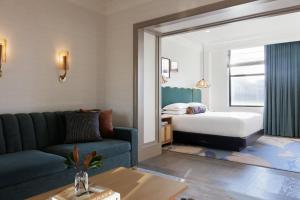 a living room with a couch and a bed at Kimpton Hotel Monaco Philadelphia by IHG in Philadelphia +101 photos