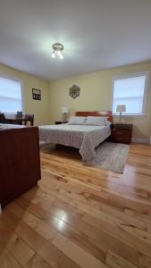a bedroom with a bed and a wooden floor at Small Town Bound Inn in Vernon River