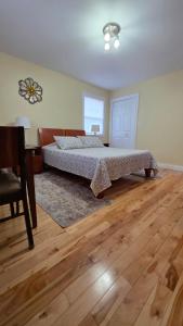 a bedroom with a bed and a table and a desk at Small Town Bound Inn in Vernon River