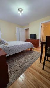 a bedroom with a bed and a table in it at Small Town Bound Inn in Vernon River