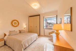 a bedroom with a bed and a desk with a lamp at Villa Sant'Alfonso in Scala +72 photos