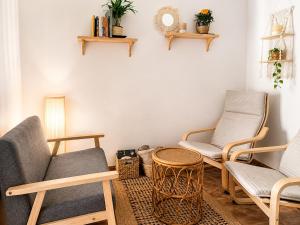 a living room with two chairs and a table at Casa del Agua- Casa rural con encanto en Sierra Nevada terraza y chimenea in Abrucena +24 photos
