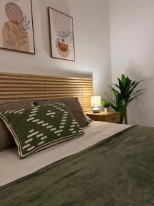 a bedroom with a bed with a wooden headboard at Maison Piave 35 in Olbia