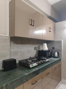 a kitchen with a stove and a counter top at LivShared in Patna