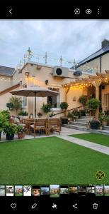 a large building with a bench and an umbrella at THE NEW Accommodation FREE complimentary breakfast and parking in Tibshelf