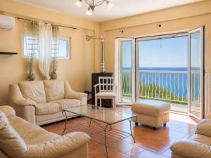 a living room with a view of the ocean at Sunset apartment by the sea in Palaiochórion