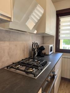 a kitchen with a stove and a microwave at Maison Piave 35 in Olbia +14 photos