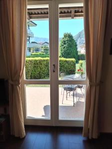 an open door with a view of a patio at Lake's dream in Feriolo