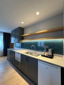 a kitchen with a sink and a counter top at Cher Hotel Eyüp in Istanbul