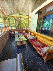a large room with couches and a table at Chander Guest House in Kasol