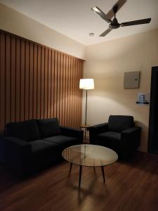 a living room with a couch and a coffee table at LivShared in Patna
