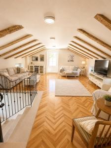a large living room with wooden floors and wooden ceilings at Cotton House Pool & Garden in Novi Vinodolski