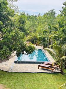 a swimming pool in the middle of a yard at Stone Garden in Dickwella +5 photos