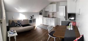 a kitchen and living room with a couch and a table at Haus Tirolerland in Oetz