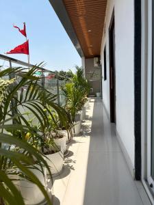 a balcony with plants and a flag on a building at The Cozy Petals in Gaya