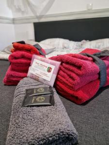a medal laying on top of a bed with blankets at Haus Oberberg - 5 min do plaży - 1 min do lasu - 5,0 na Google in Wilkasy +118 photos