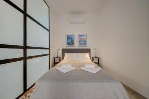 a bedroom with a bed with two towels on it at The Secret - R5 in Senglea