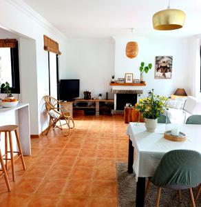 a living room with a table and a couch at B&B Villa Pinos Málaga in Alhaurín de la Torre