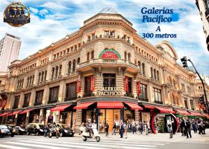 a large building with people walking in front of it at Hotel Tres Sargentos in Buenos Aires