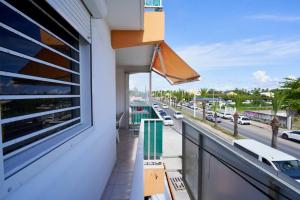 a balcony with a view of a city street at Résidence Le Lagon in Sainte-Anne