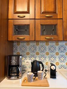 a kitchen counter with two coffee cups and a microwave at Sea Breeze Terrace in Monopoli