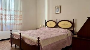 a bedroom with a bed with two mirrors on it at A Due Onde, Viola Mare in Alassio