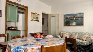 a living room with a table and a couch at A Due Onde, Viola Mare in Alassio +5 photos