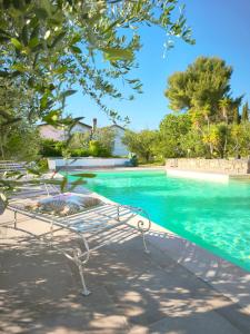 a white bench sitting next to a swimming pool at Al Castelluccio in San Vincenzo