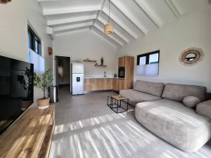 a living room with a couch and a kitchen at Emma Luxury Pool Suites Resort in Willemstad