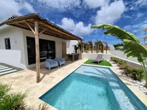 a swimming pool in the backyard of a villa at Emma Luxury Pool Suites Resort in Willemstad