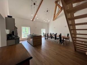 a large living room with a table and chairs at La Cascade in Mouthier-Haute-Pierre