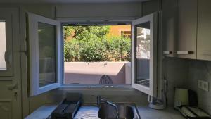 a kitchen with a window and a sink at JP Luxury Apartment 2 in Chios