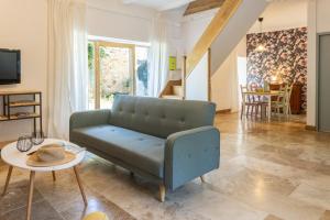 a living room with a couch and a table at Camping and Gîtes - Le Mas d'Ayen in Ayen