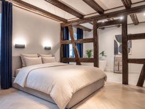 a bedroom with a large bed and a large window at Maison Alsacienne 4Ch & Suite Parentale sur la Route des Vins in Marlenheim