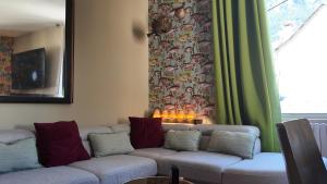 a living room with a couch and a window at FLORAC AUTHENTIQUE in Florac